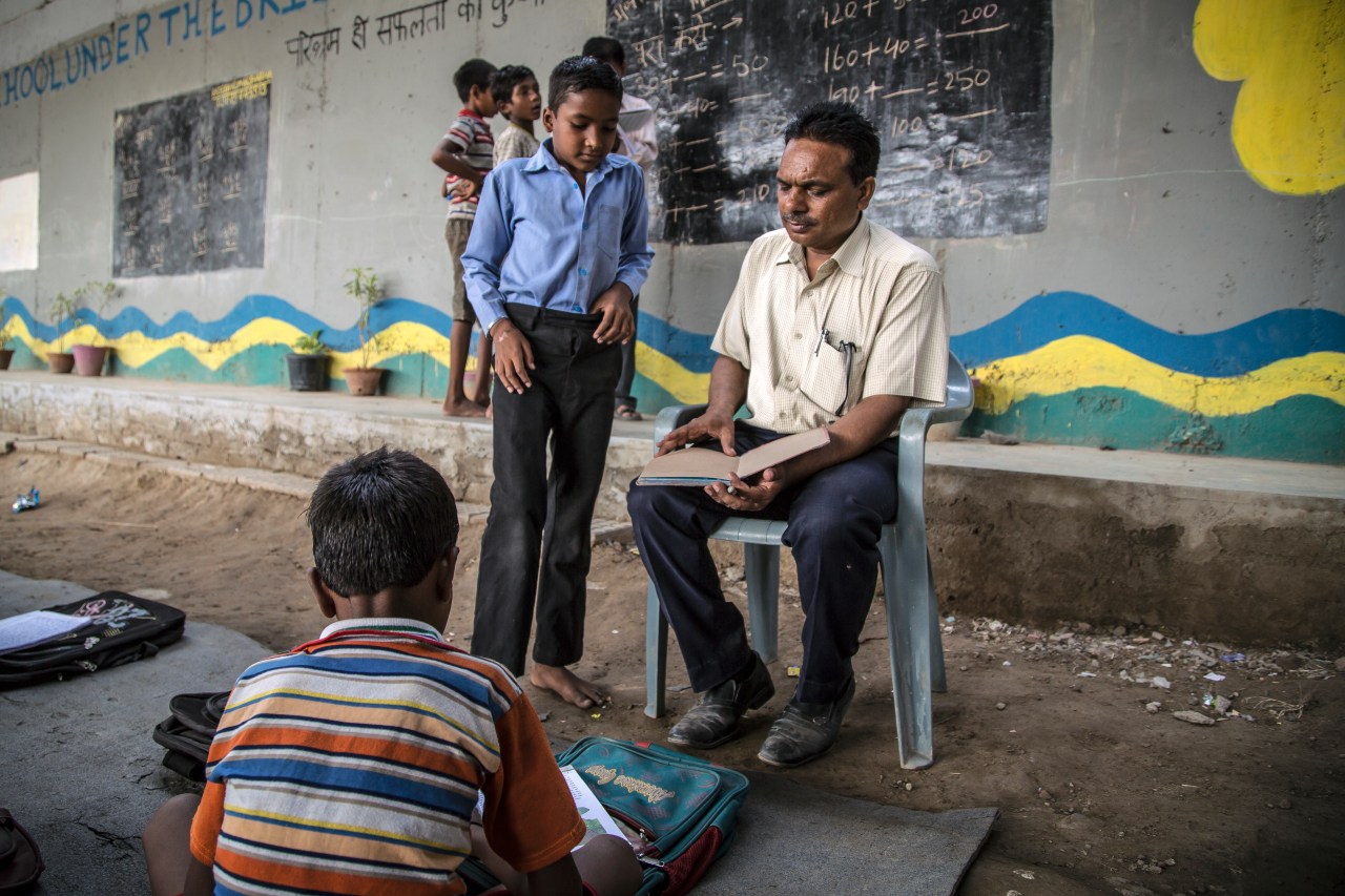 Rajesh Kumar Sharma teaches a student at the Free School. (